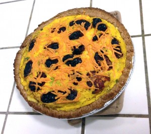A vegan broccoli quiche topped with Daiya and sundried tomato, made using the Vegg